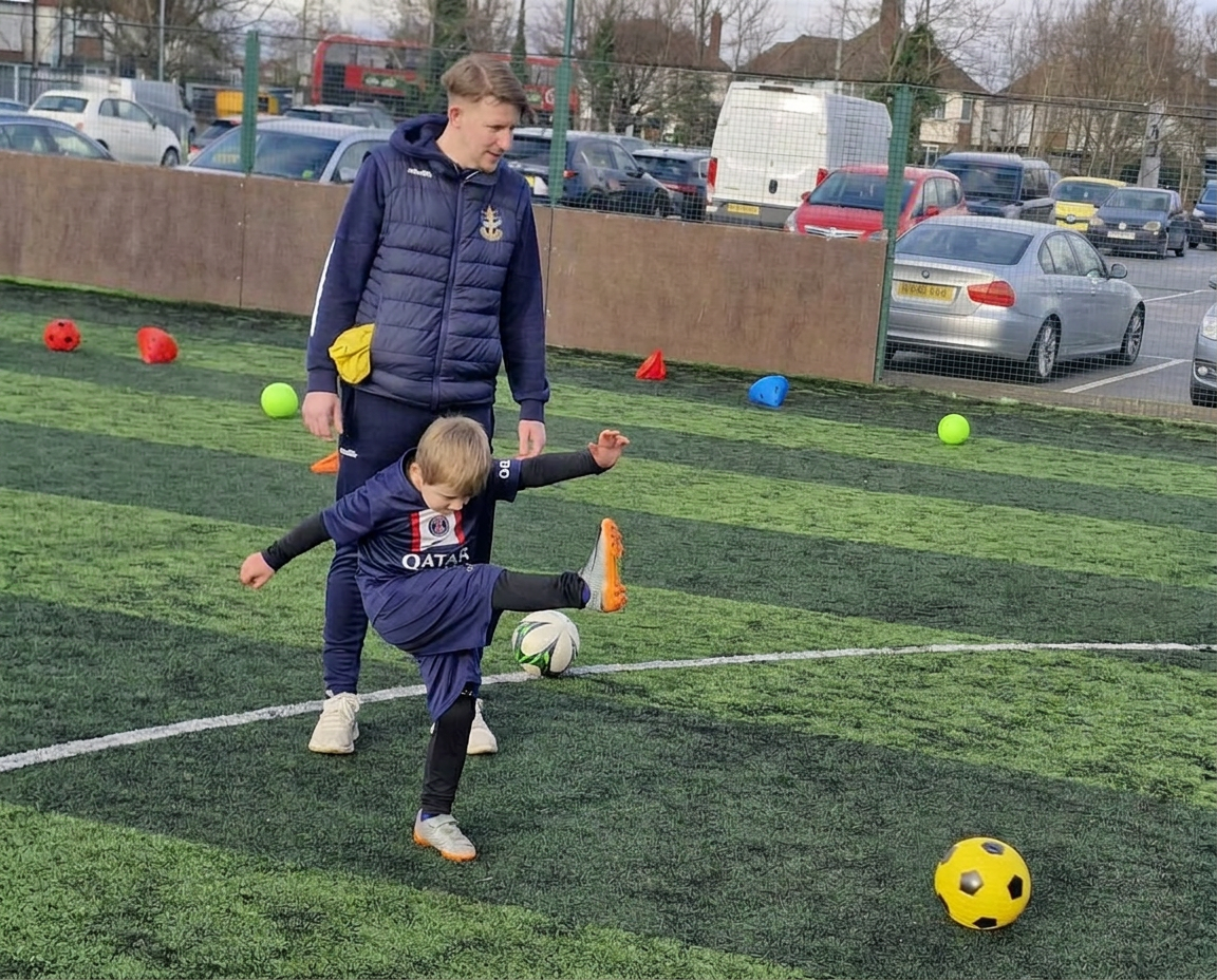 Boy kicking football