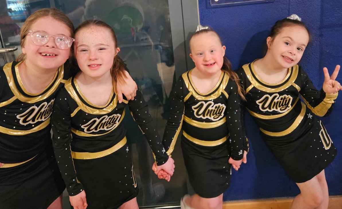 Four girls dressed in cheerleading outfits
