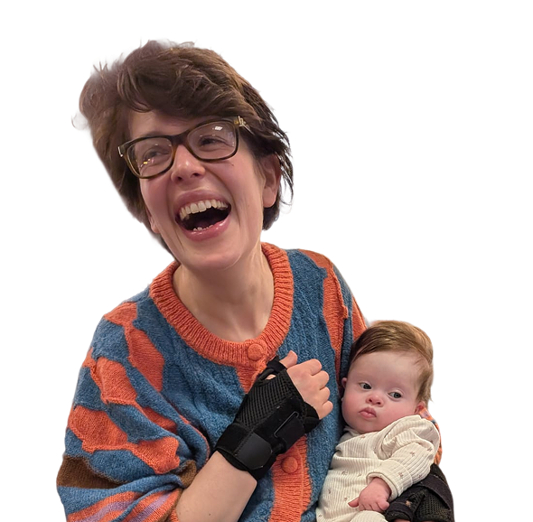 A mum laughing joyfully while cradling her newborn baby